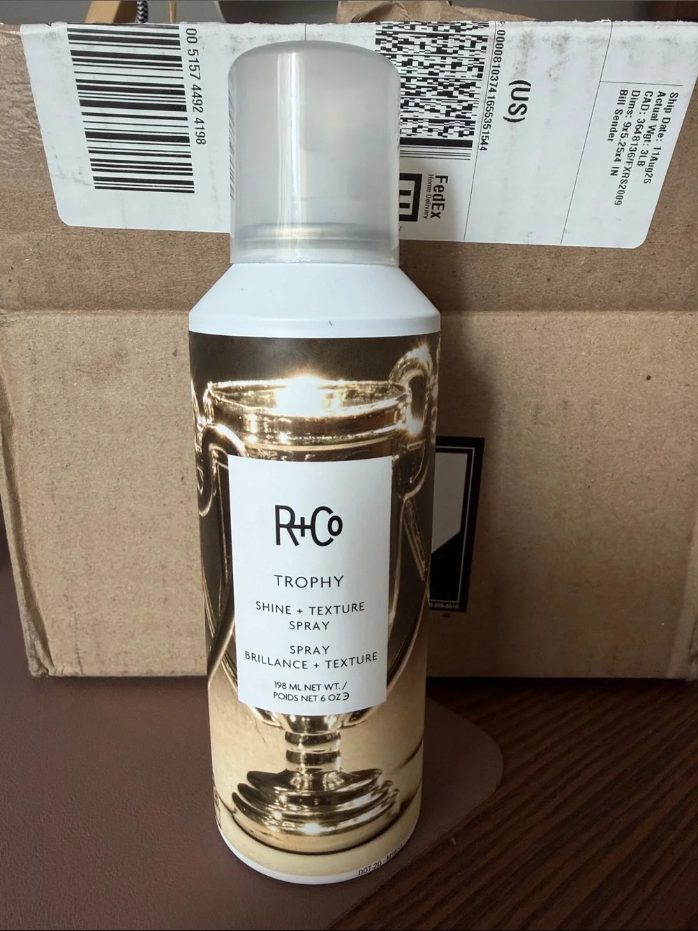 R+Co Trophy Shine & Texture Spray — Gold Bottle Accents